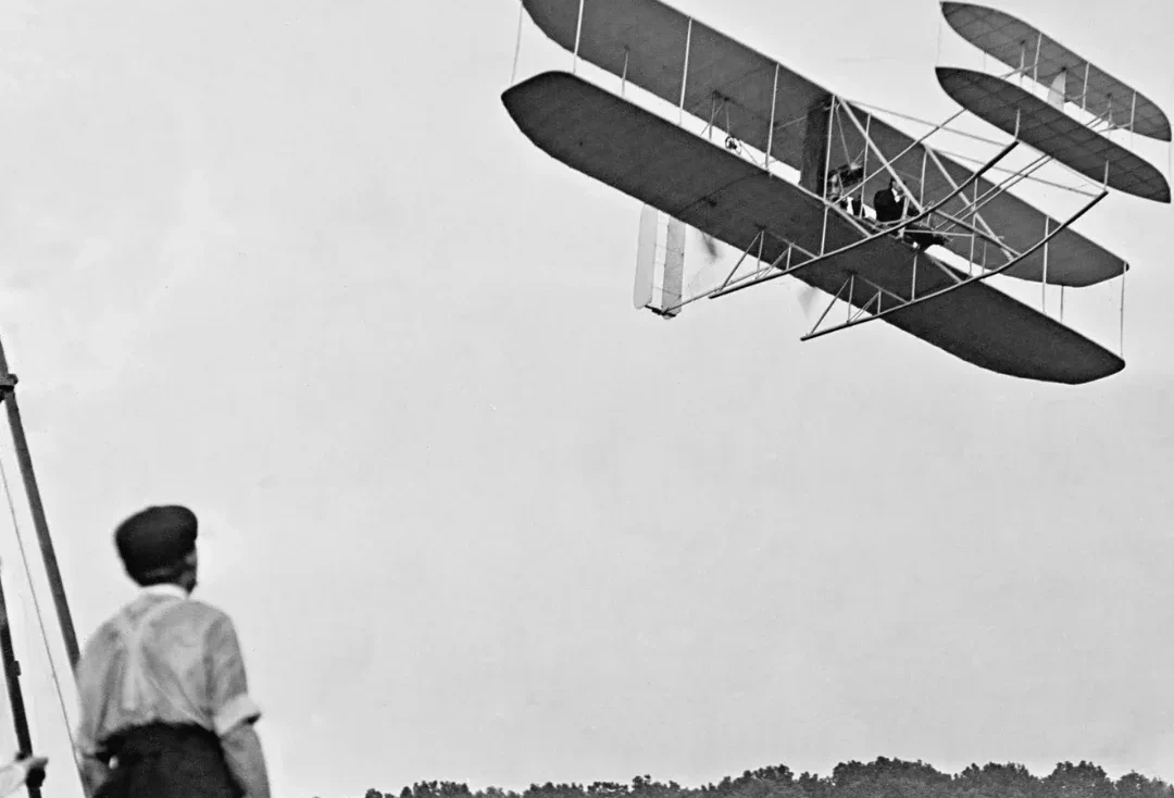 Wright brother watching a plane - black and white photo